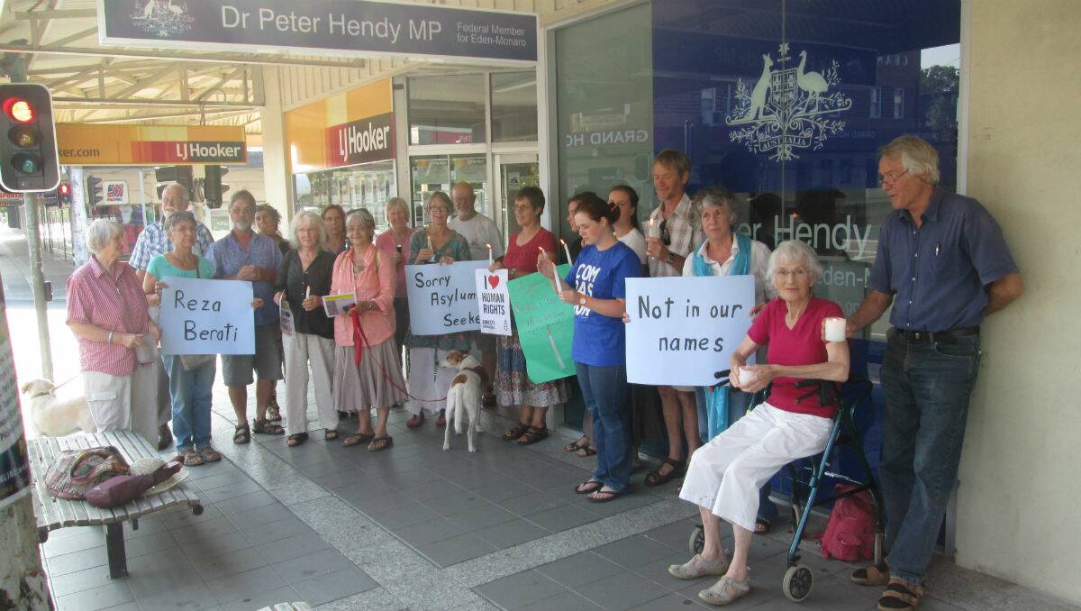 A group of Bega Valley locals gather outside MP Peter Hendy’s office in a candlelit vigil for asylum seekers being held on Manus Island.