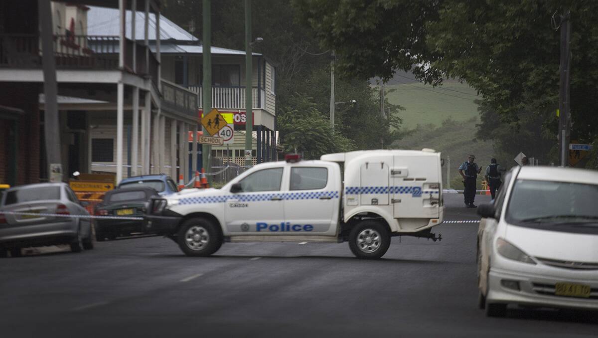 Police block Candelo's main street after two dead bodies were allegedly found in a local premises.