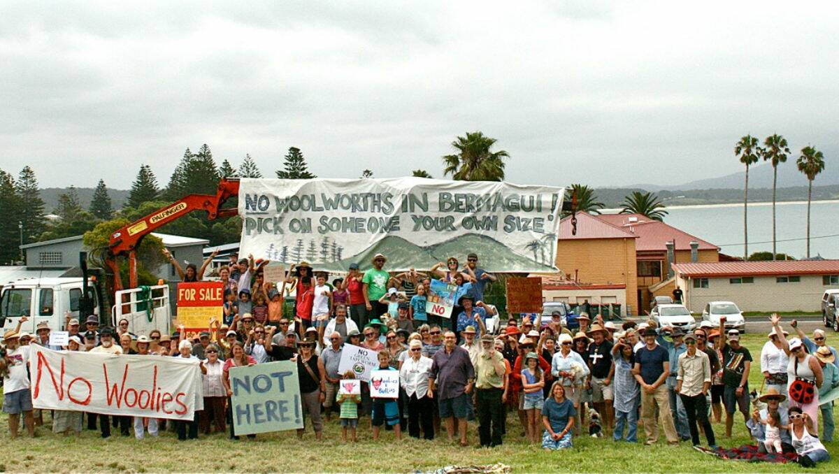 A group of residents, business owners and tourists gather on the site of the proposed Woolworths in Bermagui to express their objections to the development.