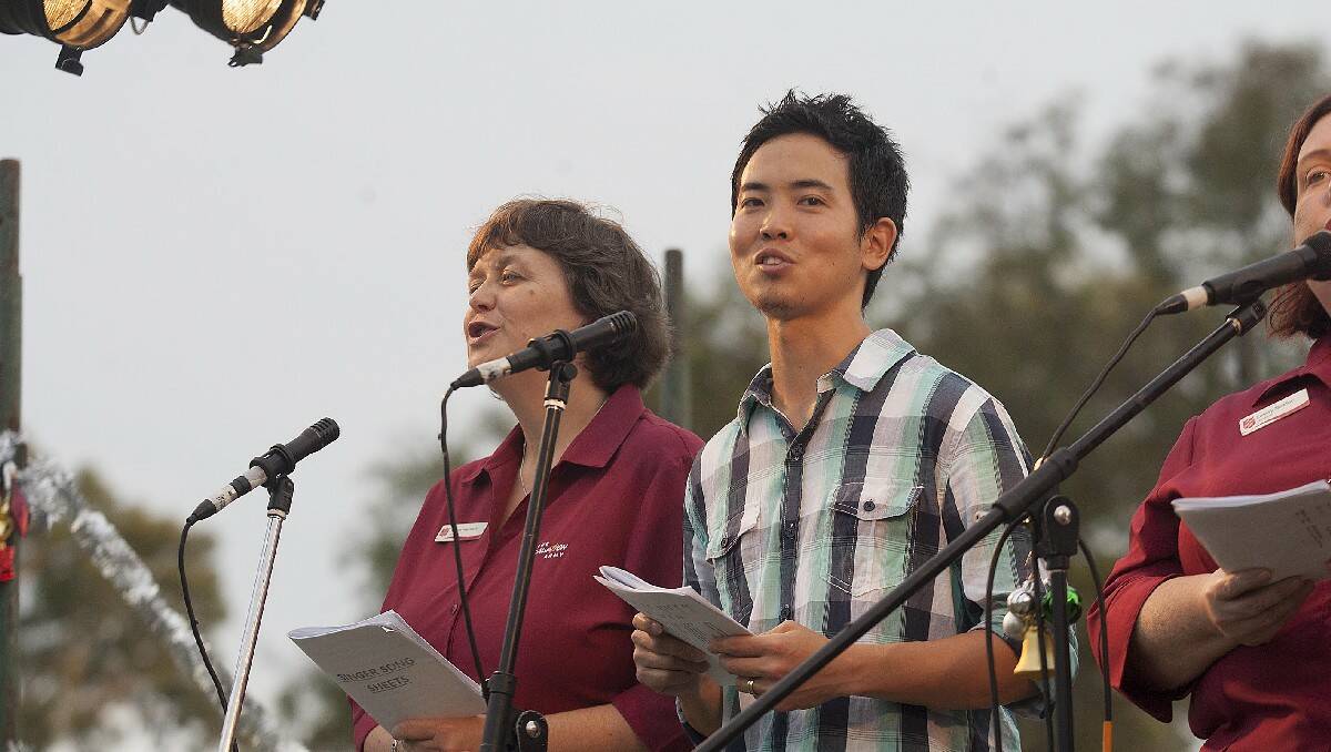 Carol singers Karen Harrison (Salvation Army) and Jimmy Watanabe (Seventh Day Adventist) entertain the crowd.