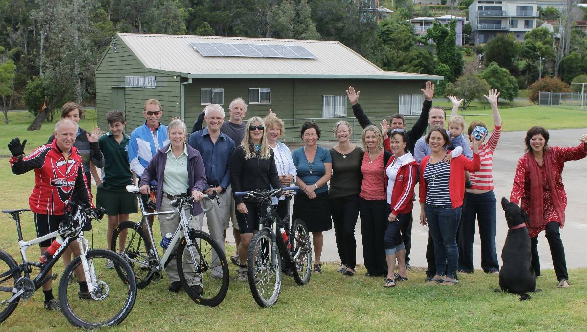 Representatives from Clean Energy For Eternity, Tathra Mountain Bike Club and NGH Environmental, along with excited community members, celebrate the solar panel installation on Tathra’s Green Shed.    