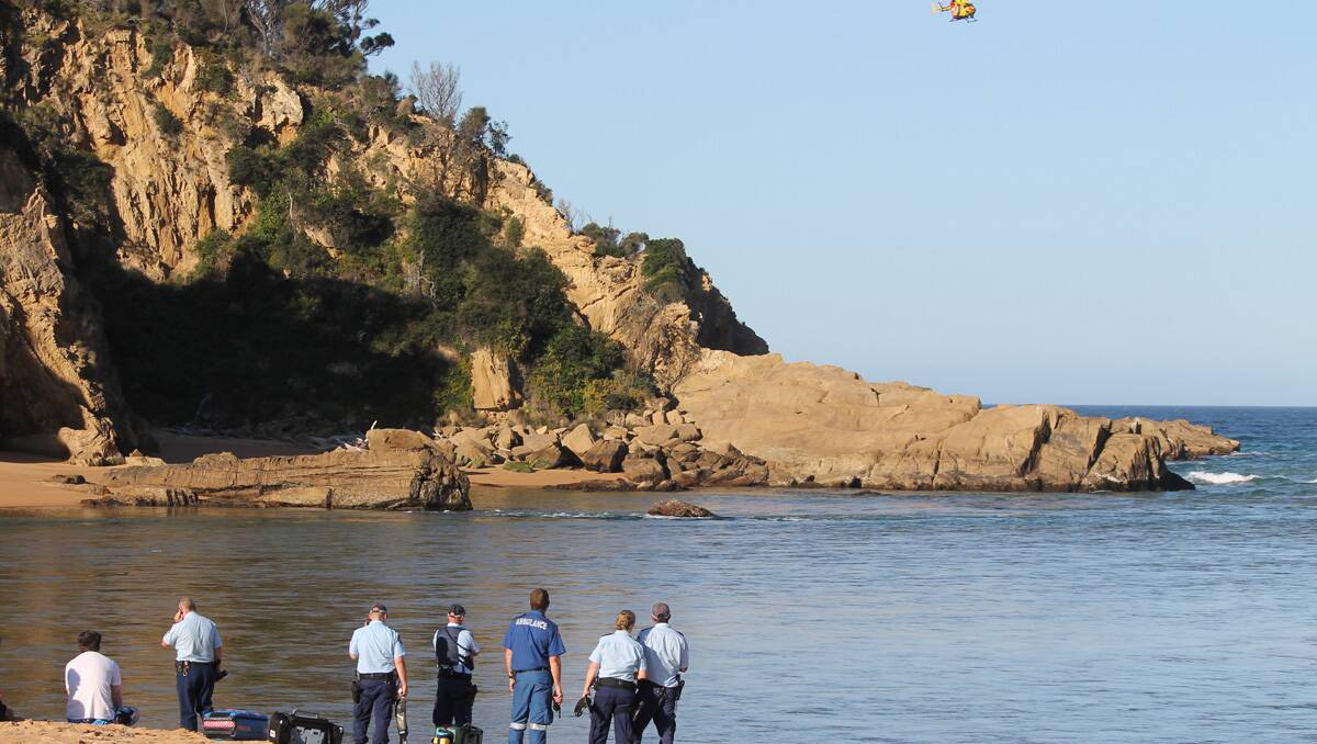 Emergency personnel including police officers, surf lifesavers, paramedics and the Westpac Life Saver Rescue helicopter conduct a search for a missing swimmer at the Bega River mouth near Tathra on Wednesday.