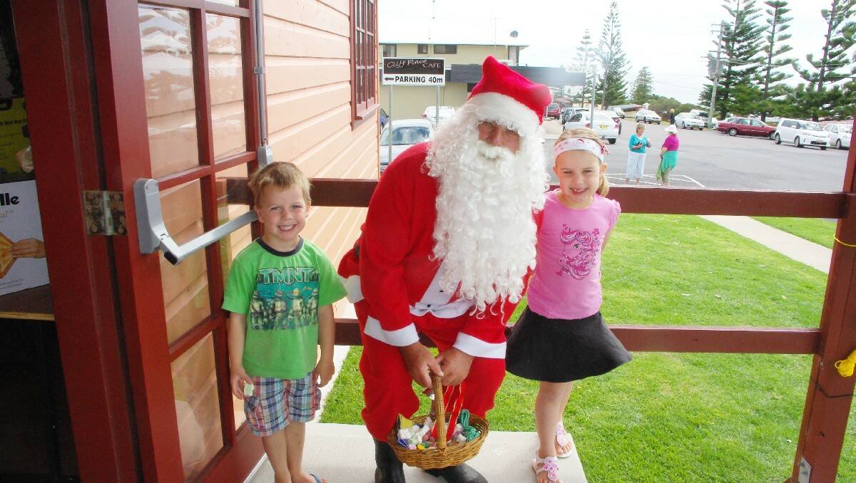 Jack and Stephanie Taylor meet Santa at the Tathra Hospital Auxiliary’s Christmas Fair.