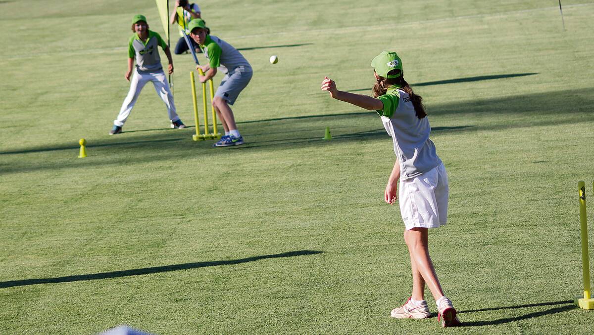• Junior Janet King (right) bowls to Will Hassan during the break at the Prime Minister’s XI match at Manuka Oval last week.