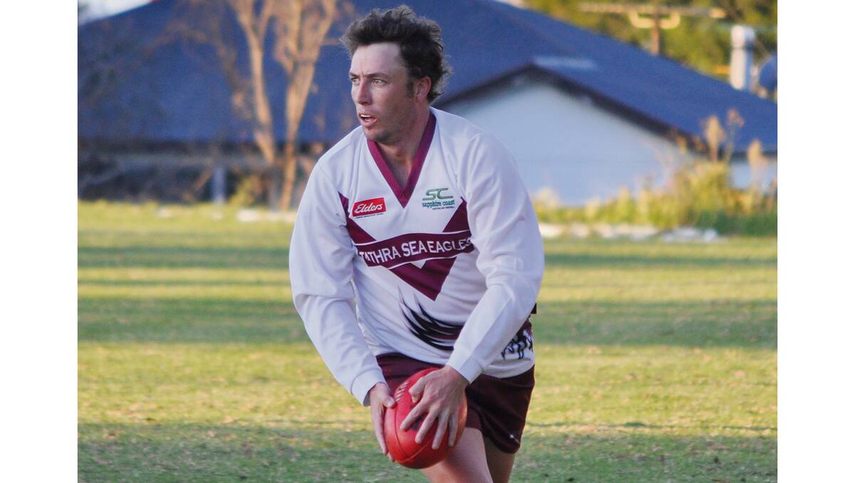 • Tathra Sea Eagles playing coach Luke Taylor runs the ball hard against the Bega Bombers at Lawrence Park. Taylor has just signed a two-year deal to stay coach of the Sea Eagles and is excited about the opportunity. 