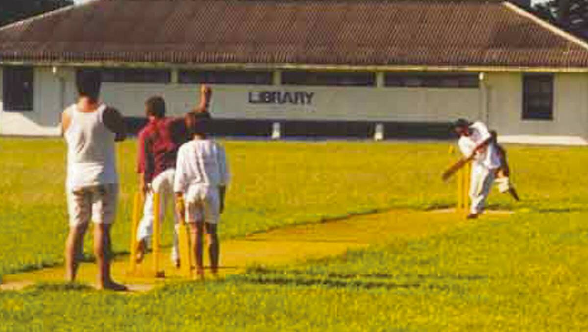• Young Tongan islanders enjoy a game of cricket on a dirt pitch. 