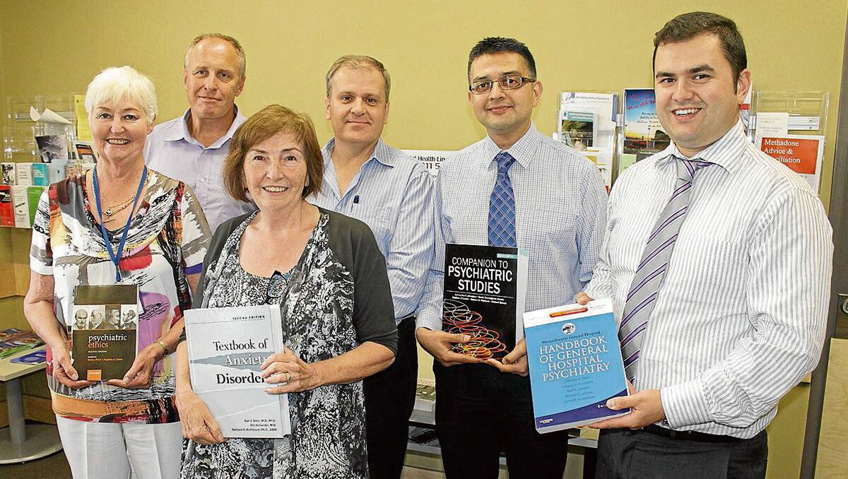 • At the text books donation to the Bega Mental Health Inpatient Unit are (back, from left) the unit’s nursing manager John Willington, Southern NSW Local Health District’s director of mental health and drug and alcohol David West, SNSWLHD clinical director Dr Pavan Bhandari, Rural Psychiatry Project representative Nick Todorovski, (front) SNSWLHD board member Jan Aveyard and Bega Valley Health Services general manager Heather Austin.