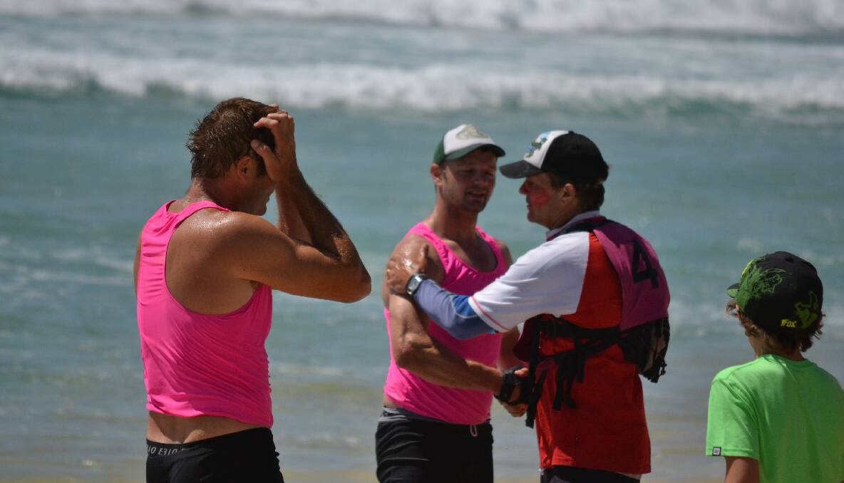 CONGRATS: Sweep Brendan Constable congratulates his rowers on the Narooma beach.  