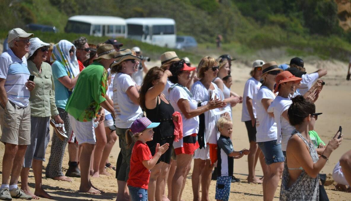 NAROOMA CROWD: A large crowd assembled to watch the surfboats arrive at Narooma.