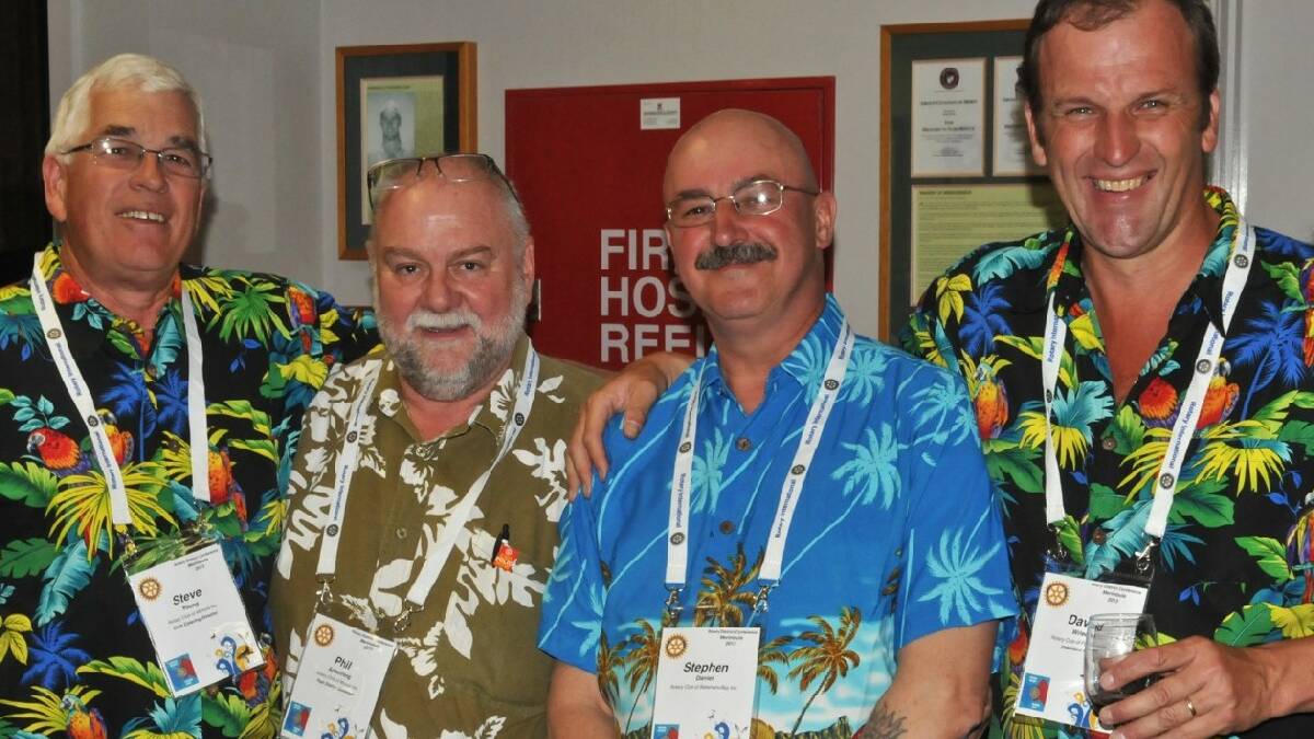 MERIMBULA: Steve Young and Phil Armstrong of the Morurya Rotary Club, Stephen Daniel of Batemans Bay and David Wriedt of Pambula Rotary celebrate their shirts at the welcome   reception.