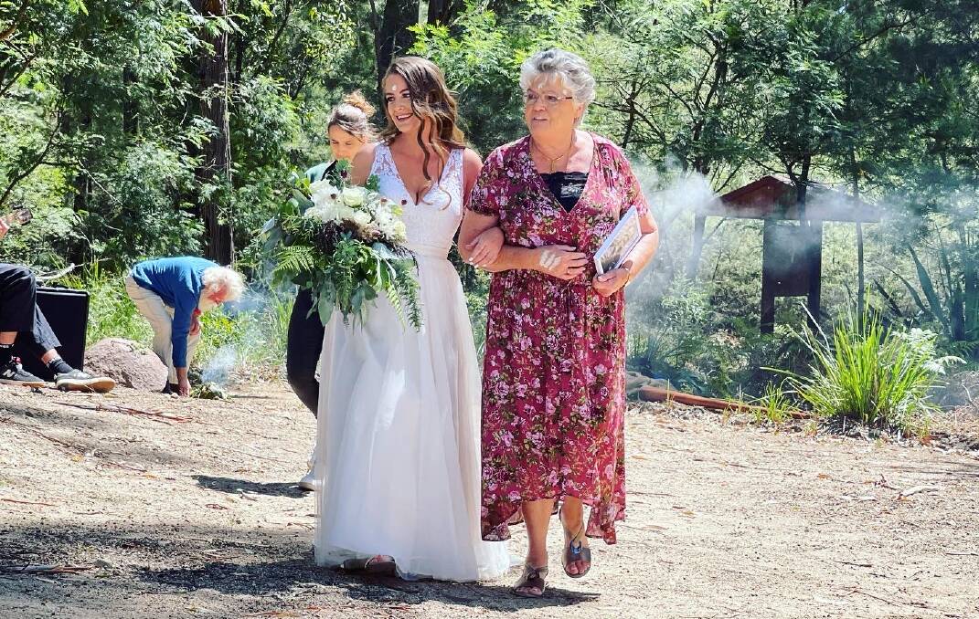 Rochelle Lygon walking towards the altar with her grandmother Yvonne Muir. Photo: Amandine Ahrens
