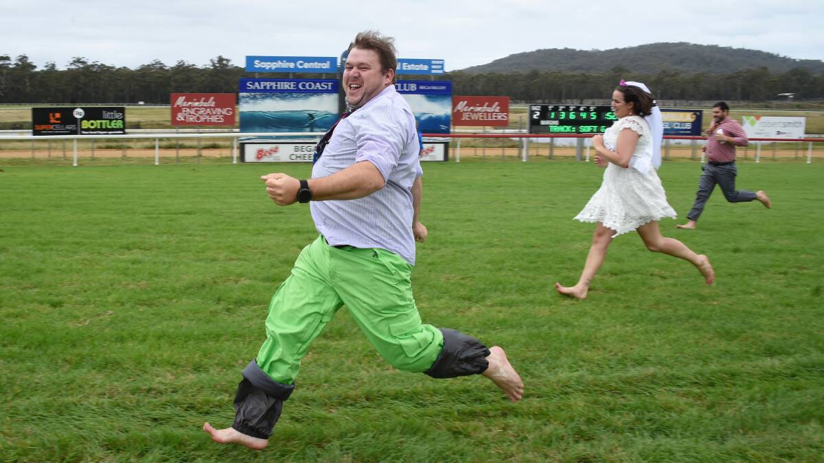 Groom Pete Nicholson wins race against three other grooms, a bride and special guest Ronald McDonald at the Bendigo Bank Pambula Cup Race Day. Photo: Supplied