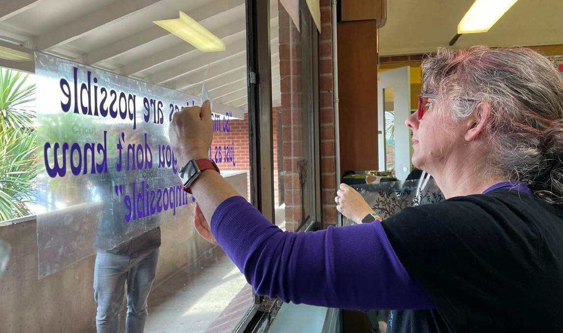 Bega High School teacher Rebecca Lupton puts up one of the motivational texts she'd chosen and created with new Cricut equipment. Photo: Amandine Ahrens