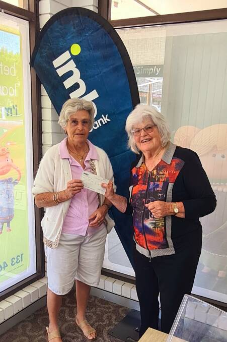 One of many community donations - Joanne Korner presents Clare McMahon with $5000 cheque raised by various local businesses and groups to refill the new hall's kitchen cupboards. 