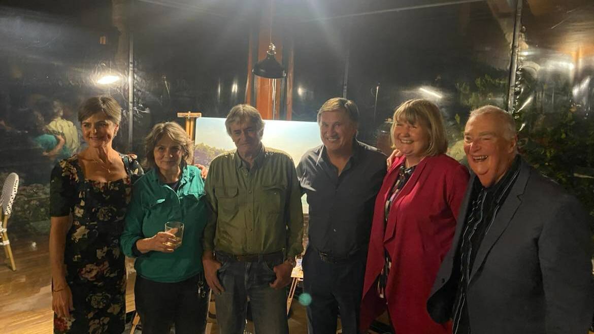 Smiles all round at the live art fundraiser hosted at Wheelers. Left to right: MC Michelle Pettigrove, artists Ann and Glenn Morton, MC Frankie J Holden and highest bidders Carolyn and Michael Saukeld. 