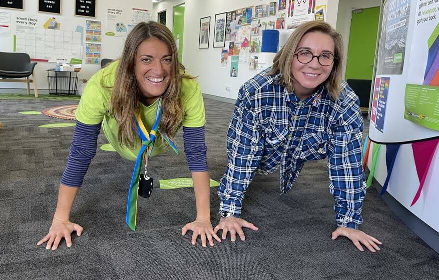Carly McDonald and Vesna Andric practice their pushups at the Bega Headspace office. Photo: Amandine Ahrens