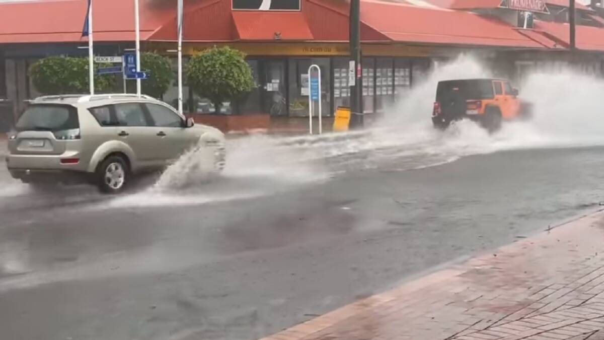 Merimbula's main street gets suddenly flooded from 3pm Thursday March 26. Screengrab of video by Kim Bowden