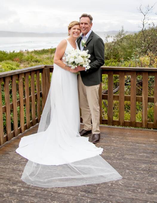 Newlyweds Jacqui Smith and Damien Foley stand on the deck overlooking Main Beach, Merimbula where Damien proposed. Picture by Daisy Hill Photography 