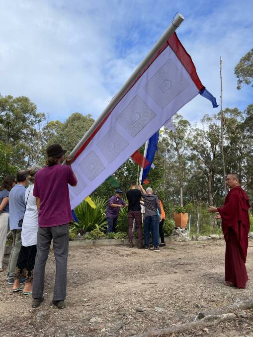 Khenpo la guides guests to raise the tall Darchog flagstaffs. 