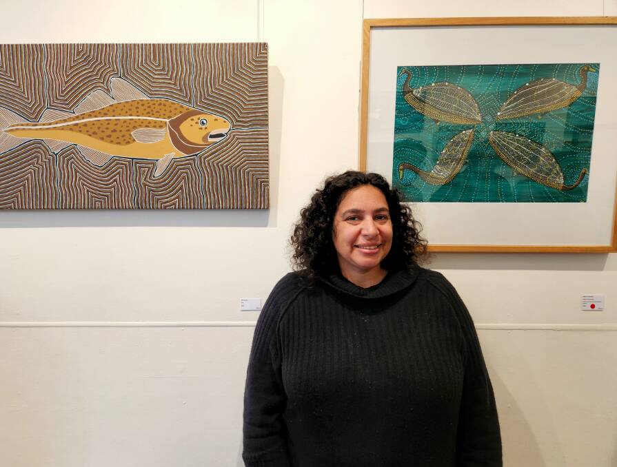 Sabrina Canavan presents her artwork 'swans swimming' (on the right) at the South Coast Indigenous Artists Exhibition at Spiral Gallery's opening day on August 12, 2023. Picture by Amandine Ahrens. 