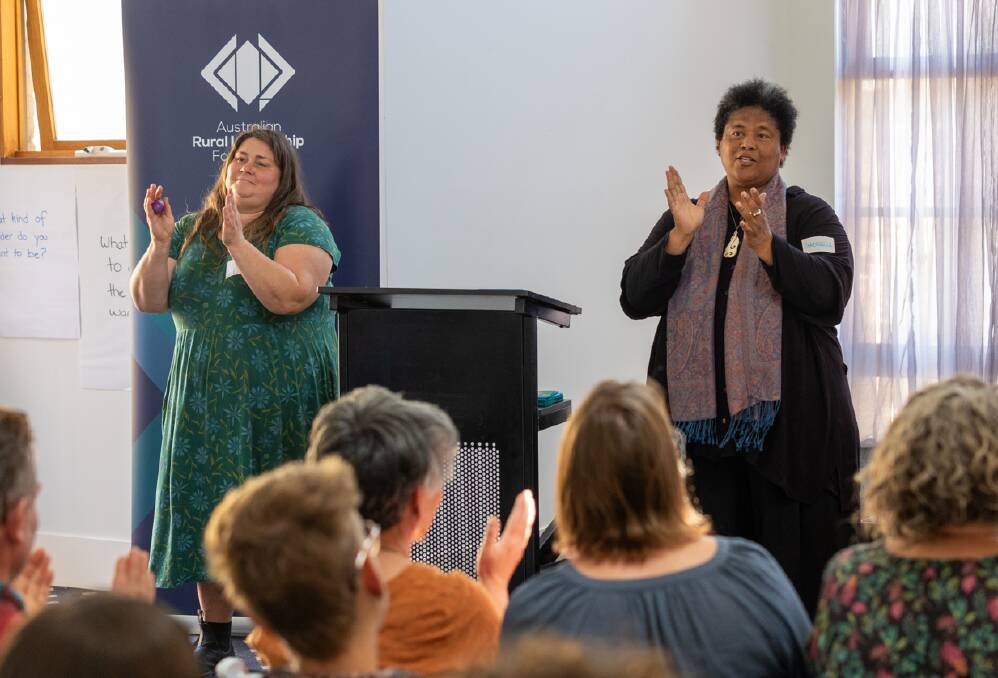 Anna Lindstrand of Candelo and Gabrielle Jones of Bega get up and encourage everyone to sing and clap at the Bega Valley leadership development program graduation ceremony. Picture supplied. 
