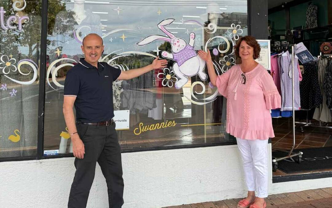 Nathan O'Donnell and Sharon McKill out the front of Swannies with their Easter decorated windowpane painted by Ness Heinze-Graham. Picture by Jess O'Donnell