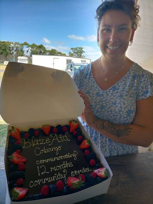 Maddy O'Connor celebrates the 12 months by bringing a cake from neighbourhood patisserie in Bermagui. Photo: Julie Brown