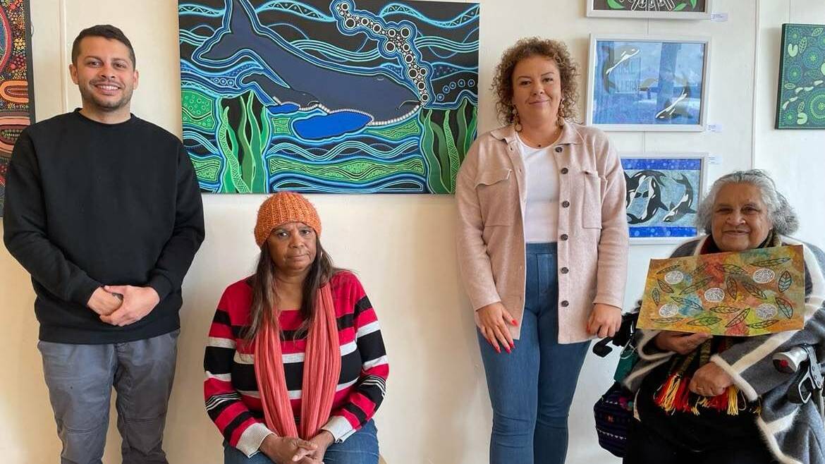 Marcus Mundy stands beside his artwork at Spiral Gallery with Ellen Mundy, Emma Stewart and Aunty Colleen Dixon. Photo: Amandine Ahrens