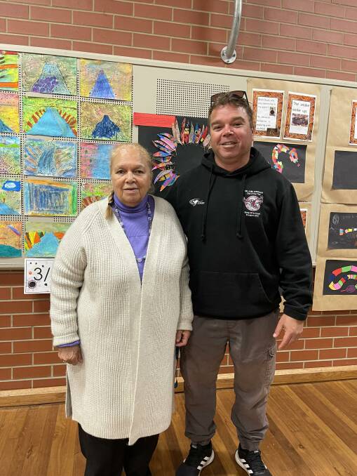 Annette and James Scott view the various artworks on display from pupils in Kindergarten through to Year 6. Photo: Amandine Ahrens