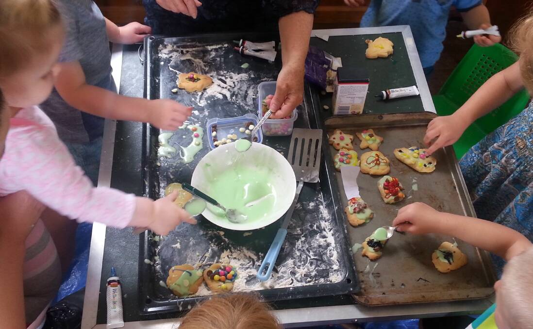 Children icing biscuits during a playgroup session with Far South Coast Family Support Service. Photo supplied. 