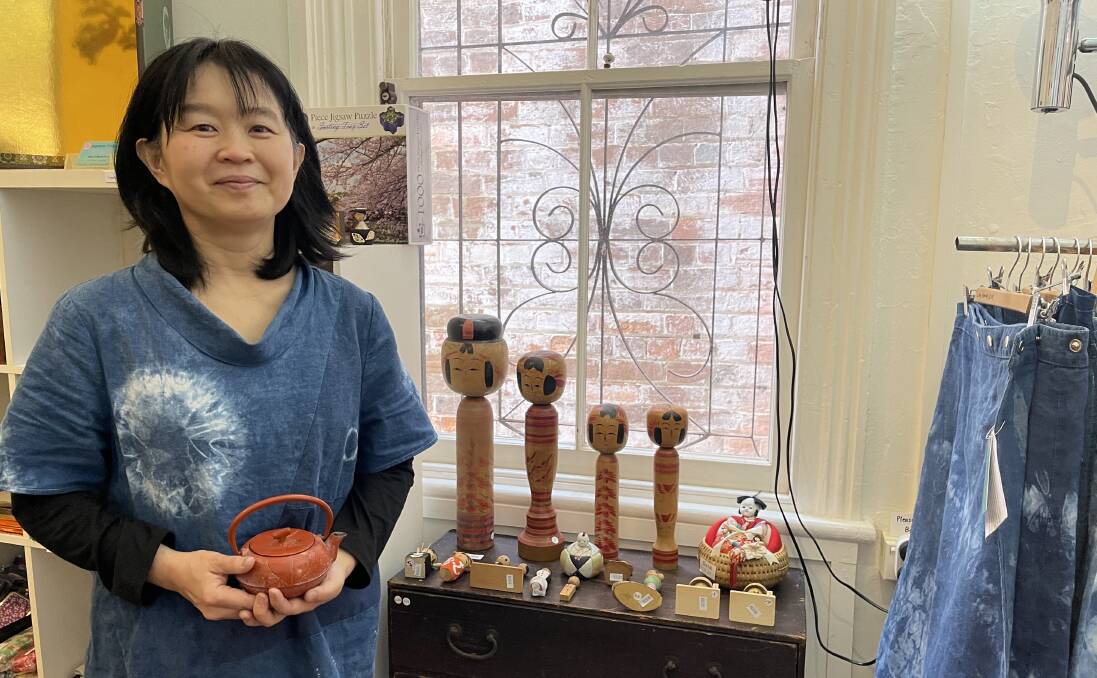 Reiko Healy stands before some of her traditional Kokeshi dolls in her Sakura art exhibition at Spiral Gallery, Bega. Photo: Amandine Ahrens