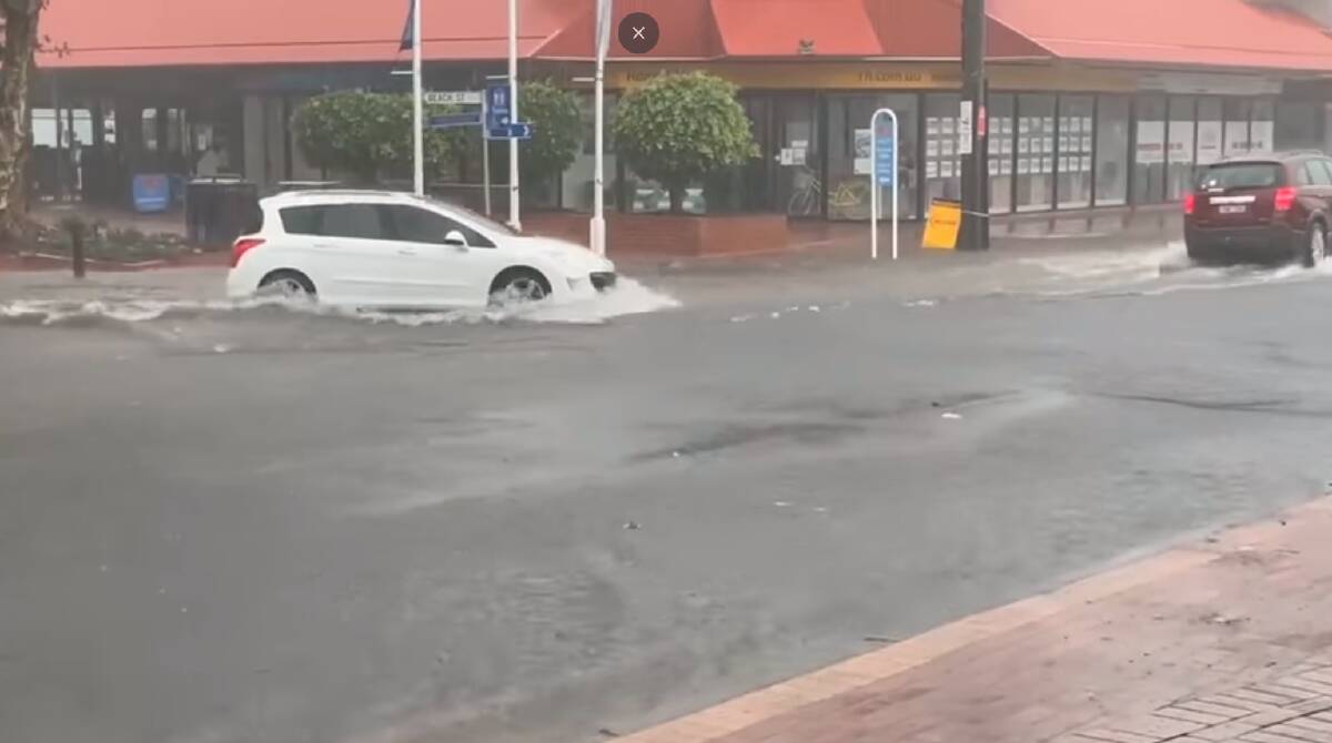 Merimbula's main street gets suddenly flooded from 3pm Thursday March 26. Screengrab of video by Kim Bowden