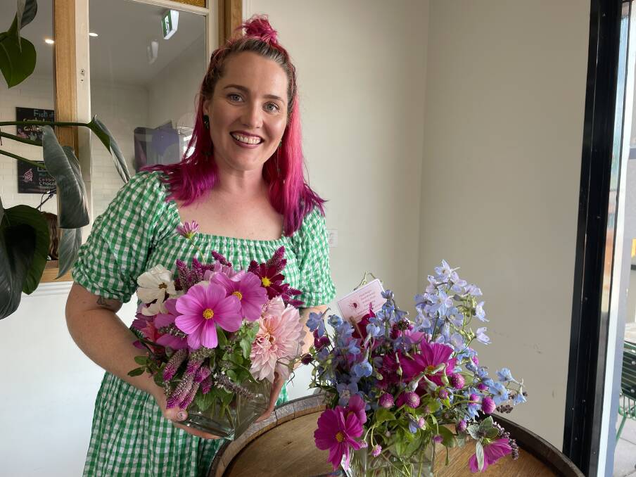 Darcie Nicol stands beside some of her beautiful arrangements she created for the International Women's Day lunch in Bega. Picture by Amandine Ahrens. 