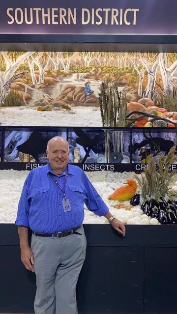 Bega's Peter Ubrihien proudly stands with 'Daffy' the squash as part of the winning Southern District display at the Sydney Royal Easter Show. Picture: supplied. 