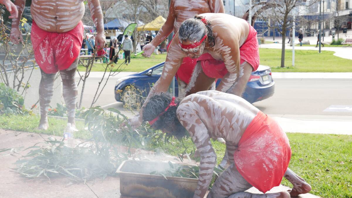 Uncle Warren Foster and the Gulaga Dancer prepare a smoking ceremony to cleanse guests at the community event on Friday July 23. 