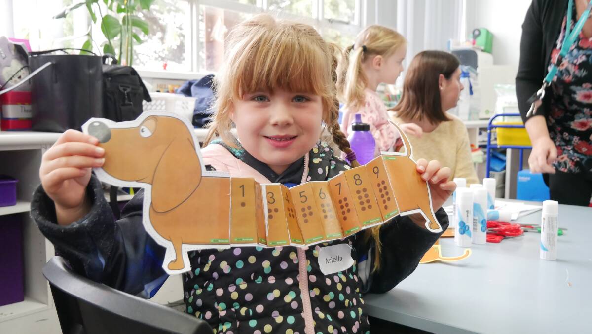 Ariella proudly holds up her sausage dog with numbered sections. Photo: Ellouise Bailey