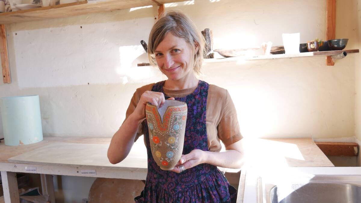 Brogo ceramic artist Sierra McManus holds up one of the pieces, inspired by vintage fabrics, that she will exhibit at Green Queen from August 13 until August 20. Photo: Ellouise Bailey
