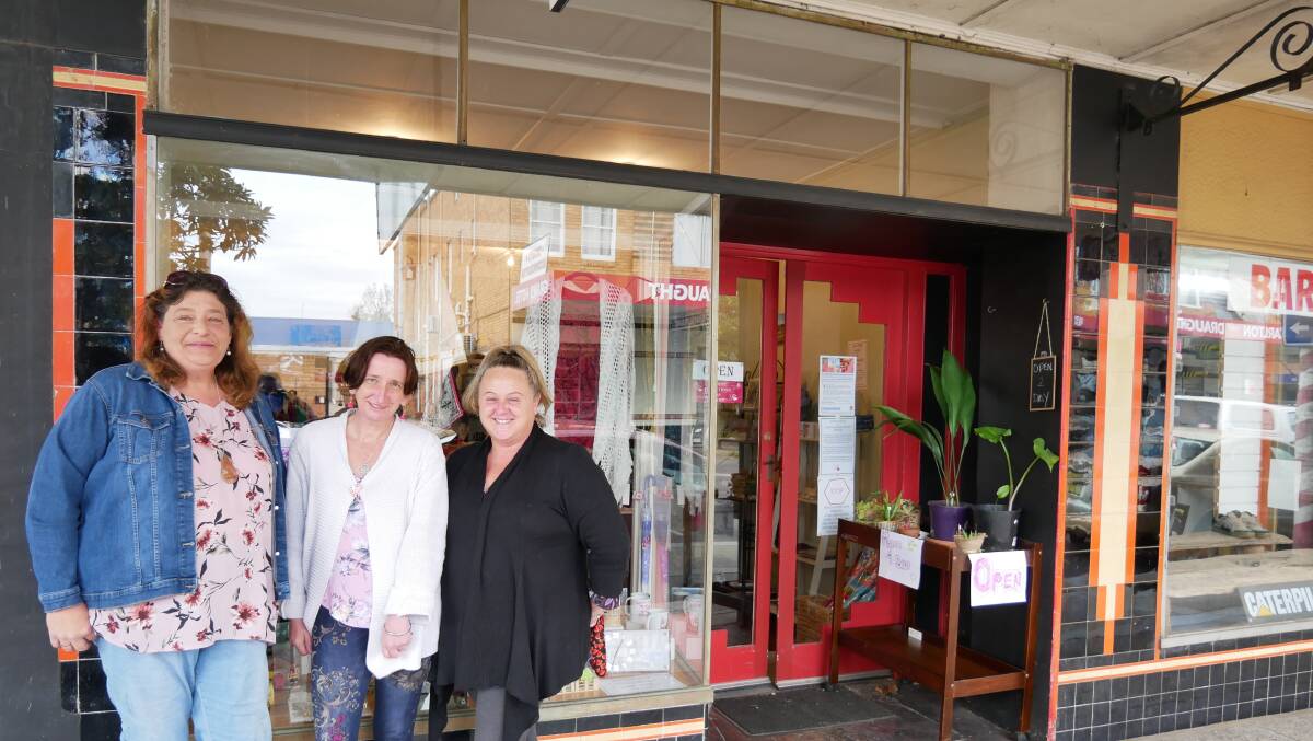 Cheryl Robinson, Helen McGlone, and Sharon Smith outside of the shop on Carp Street that is teaching retail skills, providing a space for people with disability to meet with their support workers, and allowing them to showcase some of their own artwork. Photos: Ellouise Bailey
