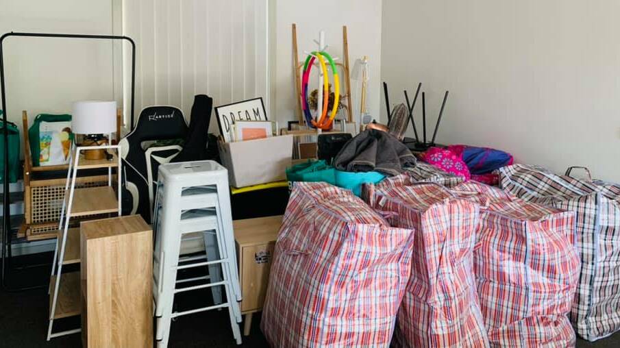 The family has been trying to pack up their home, while remote schooling three children, during a state-wide lockdown. Photo supplied
