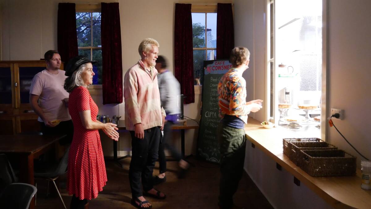 People lining up at the kitchen window for a bowl of curry before the music started. Photo: Ellouise Bailey