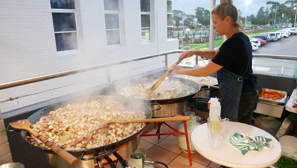 Kelly Eastwood of Eastwood's Deli preparing two of the three giant paella dishes made for guests on the night. 