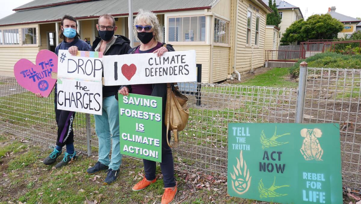 Fellow Bega Valley activists supported Sally-Anne Brown before her appearance in court with placards out the front of Eden Local Court. Photo: Ellouise Bailey