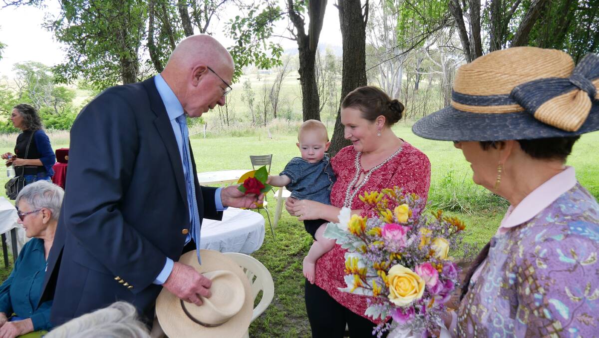Mr and Ms Hurley were presented with flowers from Cobargo woman Shelly Robertson with son Huxleyl. Photo: Ellouise Bailey