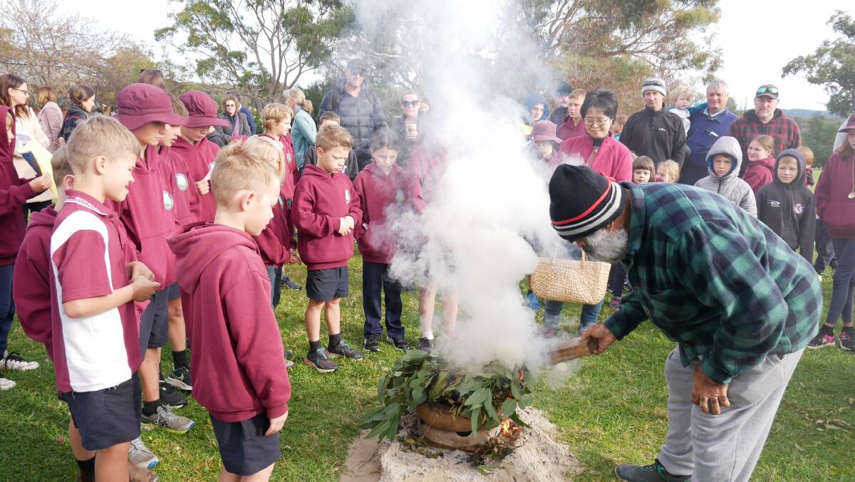 Uncle John Dixon preparing the leaves at the smoking ceremony at Tathra Public School on June 3. Photo: Ellouise Bailey