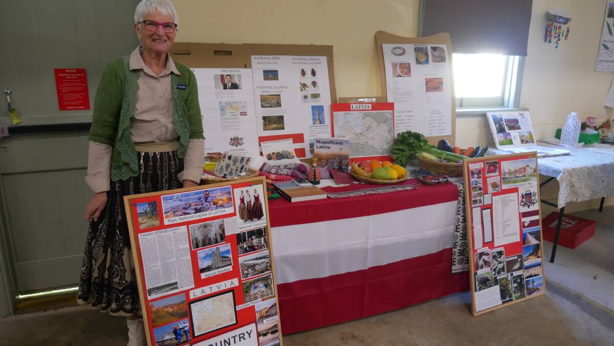 Pambula-Merimbula branch president and FSCG international officer Laraine Clarke stands next to her country of study display for 2022 - Latvia. Photo: Ellouise Bailey