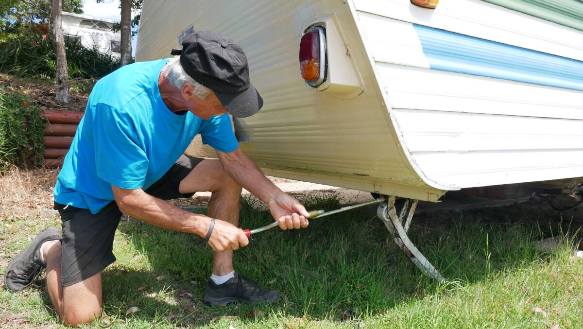Michael Brosnan works to remove a van from a caravan park and relocate it to a private property for the Christmas season. Photo: Ellouise Bailey
