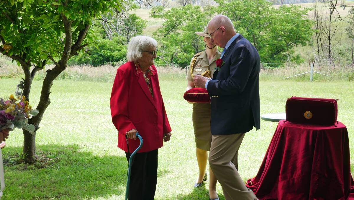 Mr Hurley presenting Ms Blacka with the Medal of the Order of Australia. Photo: Ellouise Bailey