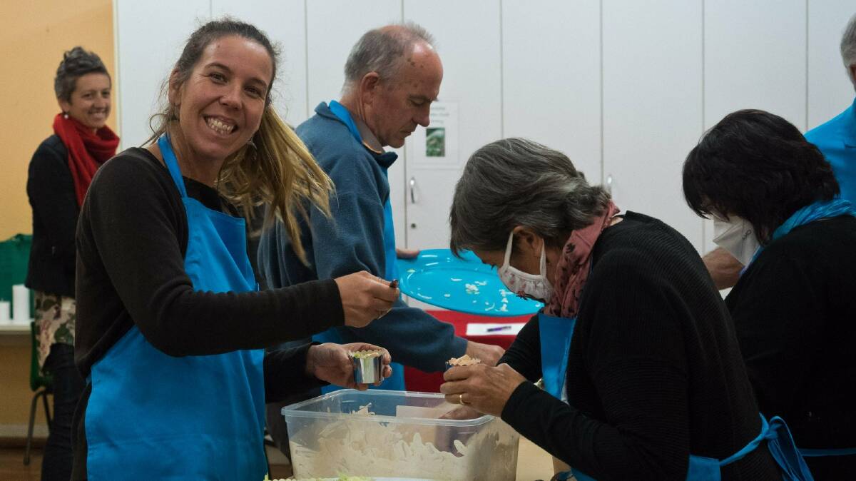 Members of the Social Justice Advocates of the Sapphire Coast helping plate and serve the meal on the night. Photo: supplied