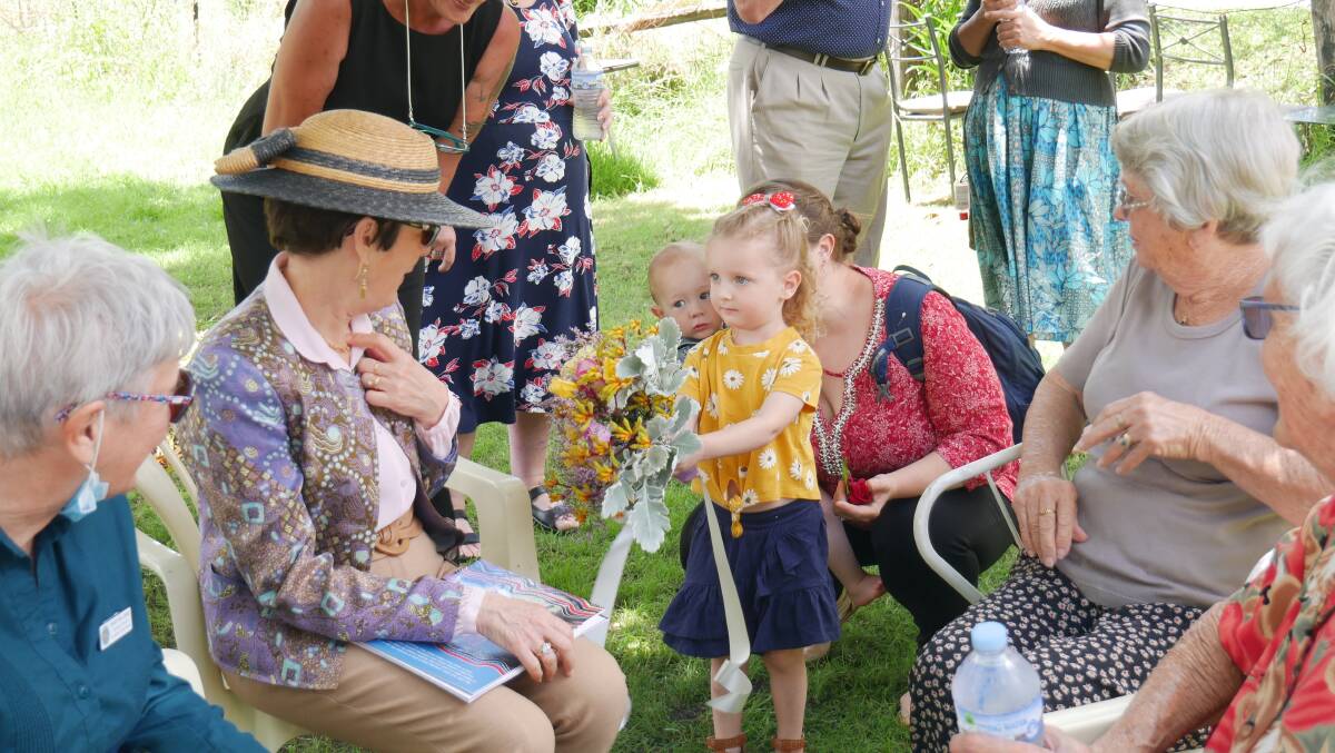 Ms Hurley was presented with flowers from Cobargo woman Shelly Robertson and daughter Hazel. Photo: Ellouise Bailey