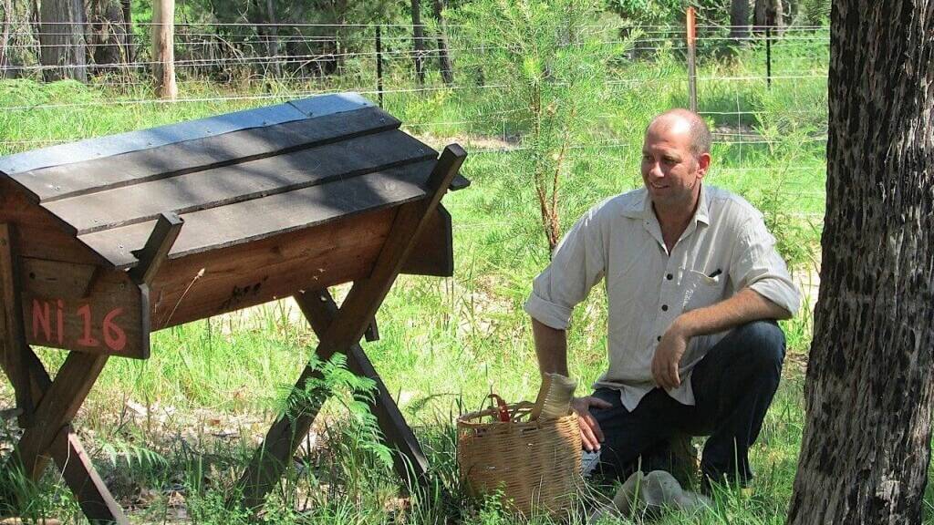 Adrian Iodice with the Kenyan Top Bar Hive which he believes is one of the most effective natural bee hives for backyard and small-scale Beekeepers. Picture: supplied 
